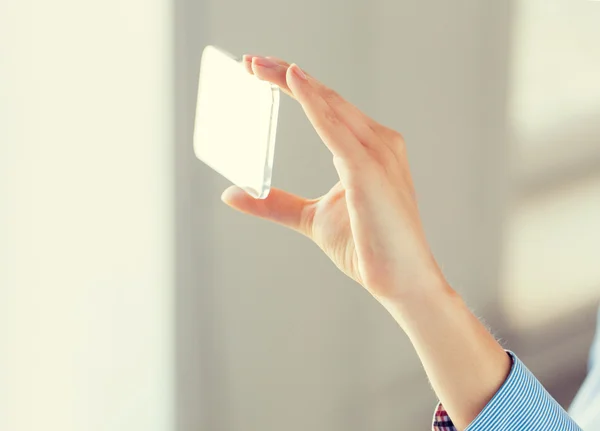 Primer plano de la mujer con teléfono inteligente transparente — Foto de Stock