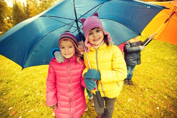 Happy children with umbrella in autumn park — 图库照片