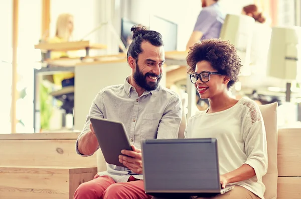 Creative team with laptop and tablet pc in office — Stock Photo, Image