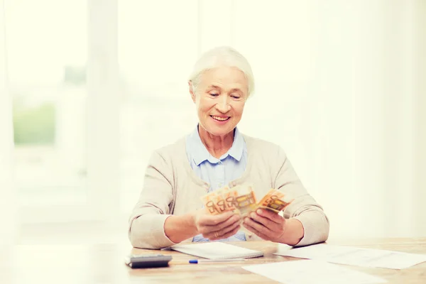 お金と自宅で書類を年配の女性 — ストック写真