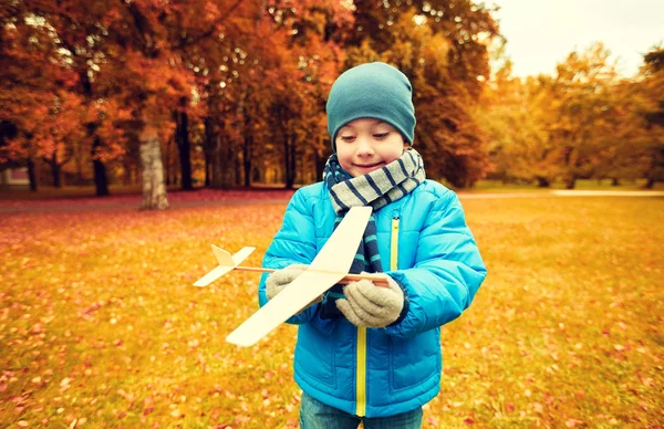 Happy little boy playing with toy plane outdoors — Stock Photo, Image