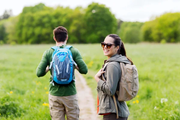Happy couple with backpacks hiking outdoors — Stock Photo, Image