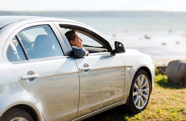 Glückliches Teenager-Mädchen oder junge Frau im Auto — Stockfoto