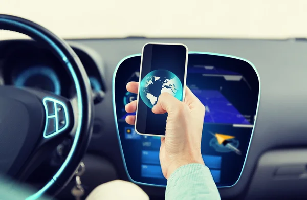 Close-up de homem mão com smartphone carro de condução — Fotografia de Stock