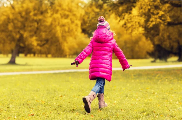 Happy little girl running in autumn park — Stock Photo, Image