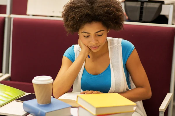 Student girl with books and coffee on lecture — Stock Photo, Image