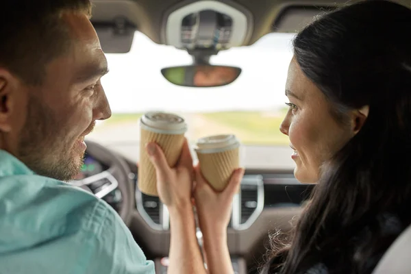 Felice uomo e donna che guidano in auto con caffè — Foto Stock