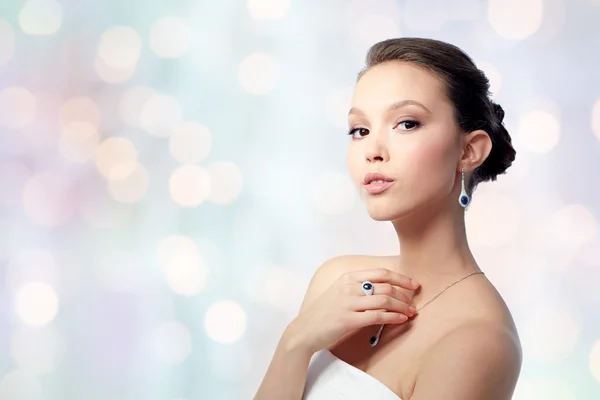 Beautiful woman with earring, ring and pendant Royalty Free Stock Photos