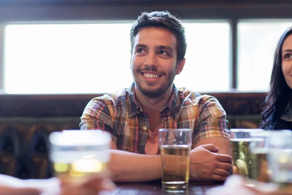 Happy friends drinking beer at bar or pub — Stock Photo, Image