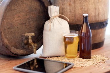 close up of beer barrel, tablet pc and malt clipart