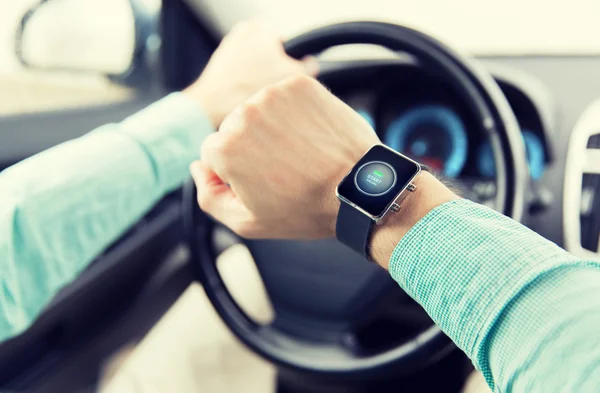 Hands with starter icon on smartwatch driving car — Stock Photo, Image
