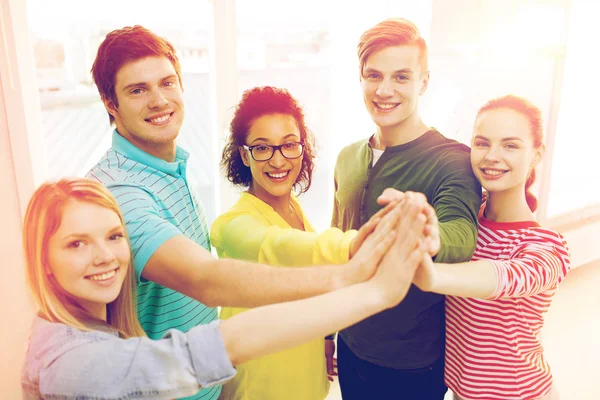 Five smiling students giving high five at school — Stock Photo, Image