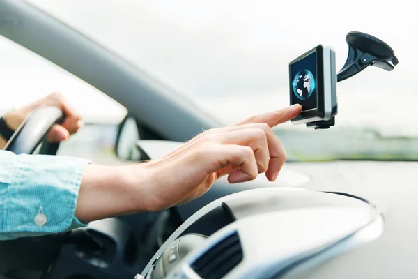 Close up of man with gadget on screen driving car — Stock Photo, Image