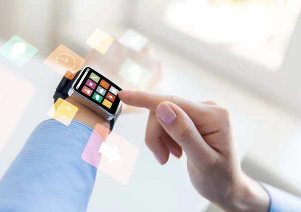 Close up of hands setting smart watch with icons — Stock Photo, Image