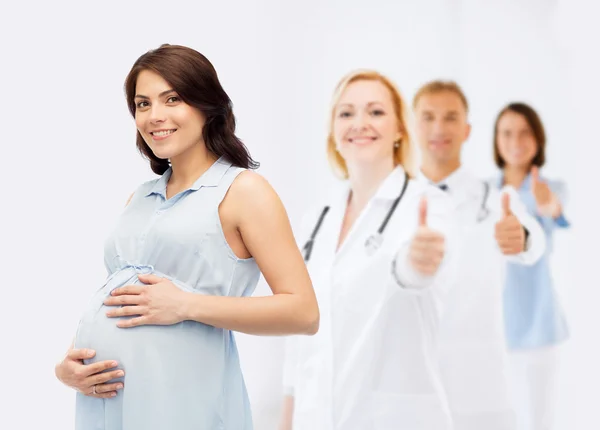 Happy pregnant woman touching her big belly — Stock Photo, Image