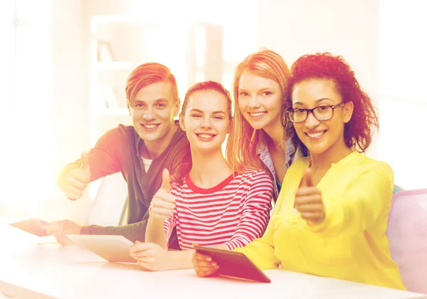 Smiling students with tablet pc at school — Stock Photo, Image