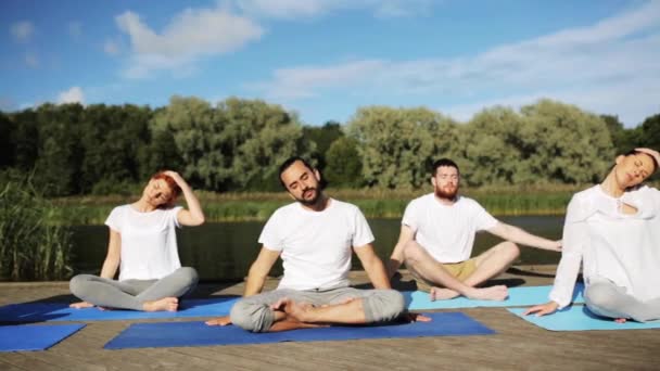 Gruppe von Menschen, die Yoga-Übungen im Freien machen — Stockvideo