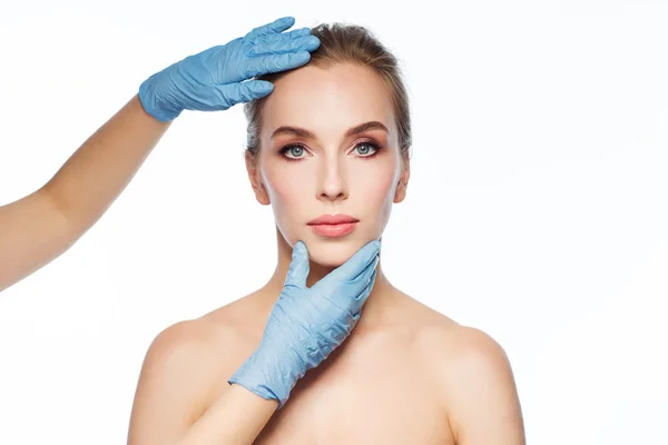 Surgeon or beautician hands touching woman face — Stock Photo, Image