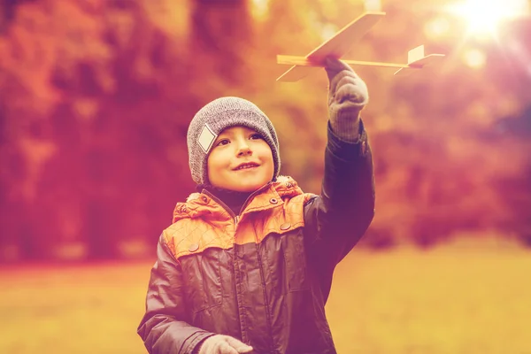 Happy little boy playing with toy plane outdoors — Stock Photo, Image