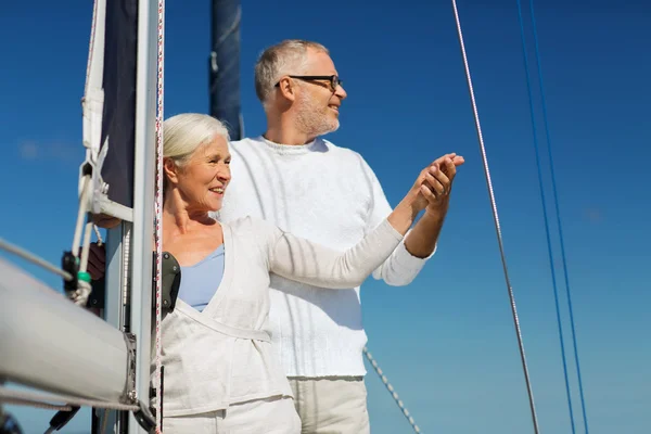 Happy senior couple on sail boat or yacht in sea — Stock Photo, Image