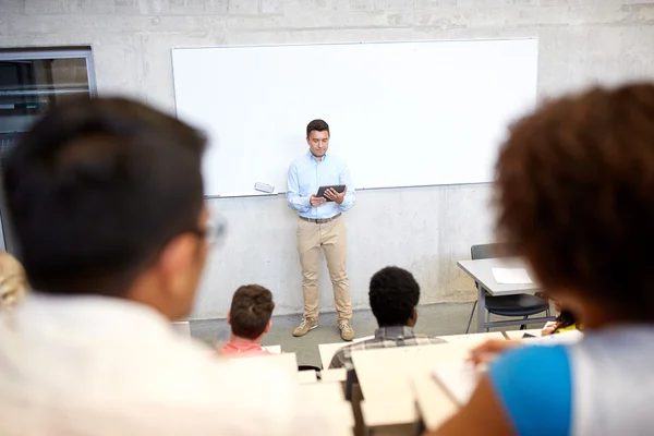 Students and teacher with tablet pc at lecture — Stock Photo, Image