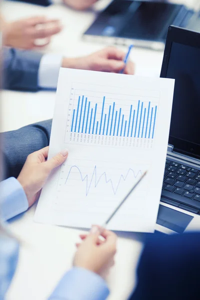 Close up of chats, laptop and graphs in office — Stock Photo, Image