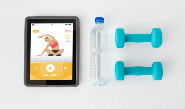 Close up of tablet pc, dumbbells and water bottle — Stock Photo, Image