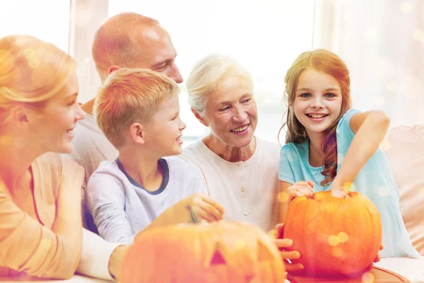 Familia feliz sentado con calabazas en casa —  Fotos de Stock