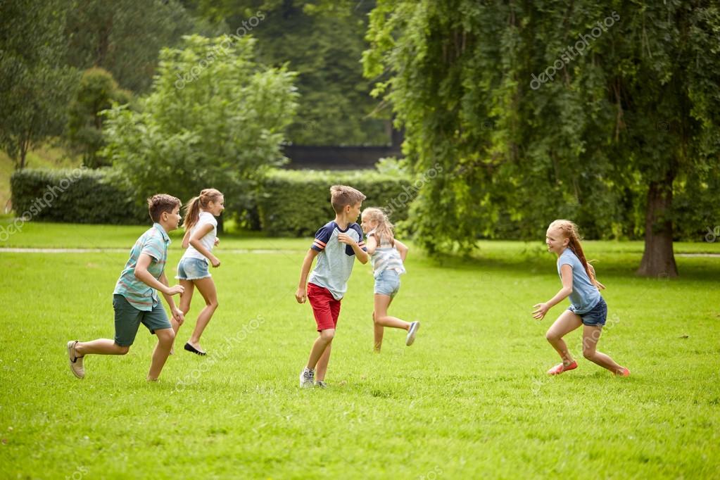 Niños felices corriendo y jugando al aire libre: fotografía de stock ...