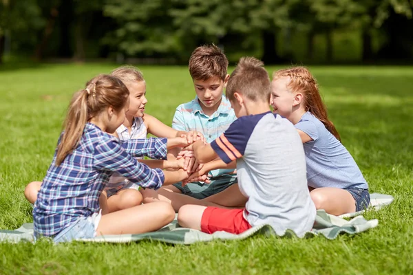 Grupo de niños felices poniendo las manos juntas —  Fotos de Stock