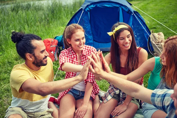 Happy friends making high five at camping — Stock Photo, Image