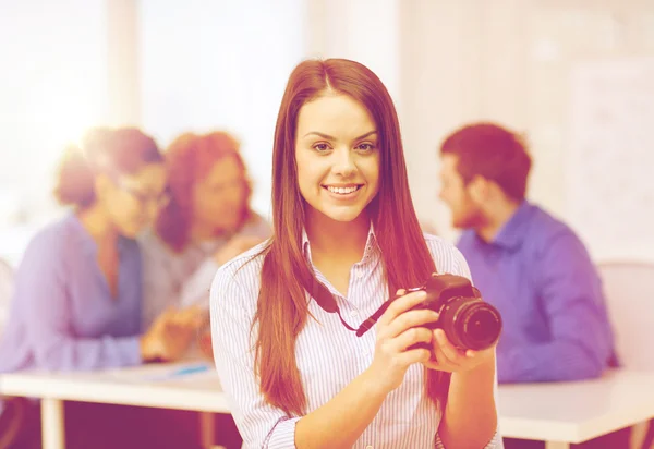 Smiling female photographer with photocamera — Stock Photo, Image