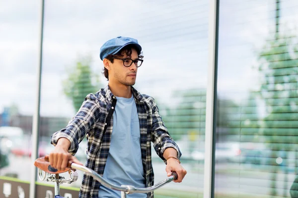 hipster man walking with fixed gear bike