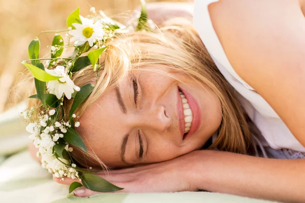 Happy woman in wreath of flowers lying — Stock Photo, Image