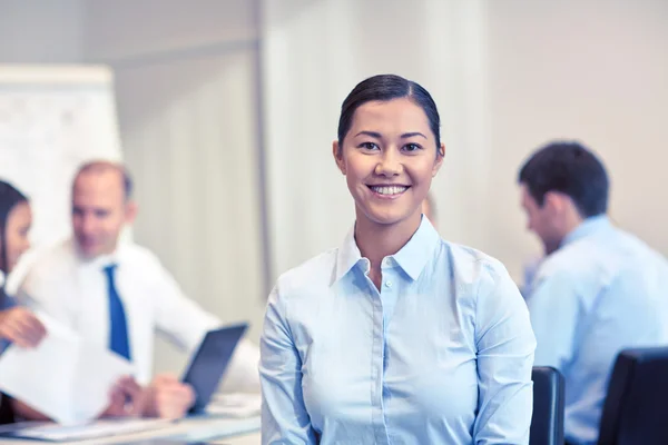 Group of smiling businesspeople meeting in office — Stock Photo, Image