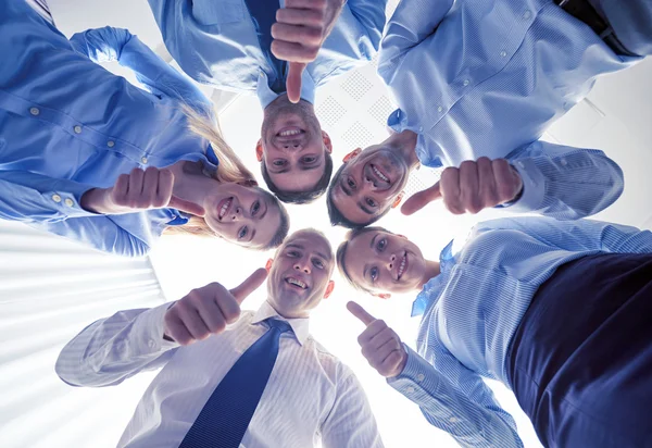 Smiling group of businesspeople standing in circle — Stock Photo, Image