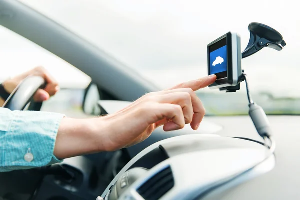 Close up of man with gadget on screen driving car — Stock Photo, Image