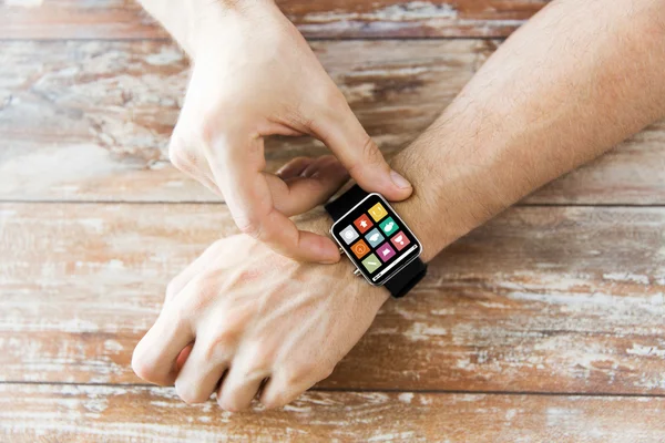 Close up of hands setting smart watch with icons — Stock Photo, Image