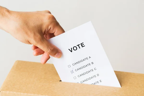 Homem colocando seu voto na urna na eleição — Fotografia de Stock