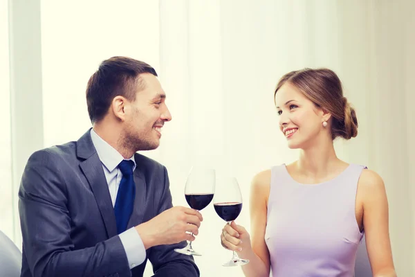 Young couple with glasses of wine at restaurant — Stock Photo, Image