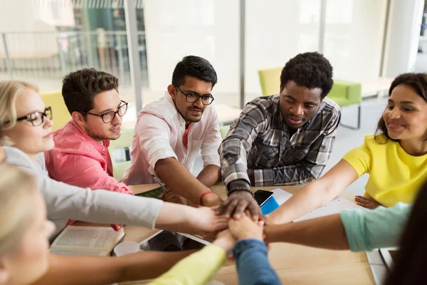 Group of international students with hands on top — Stock Photo, Image