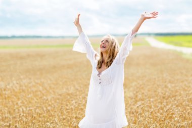 smiling young woman in white dress on cereal field clipart