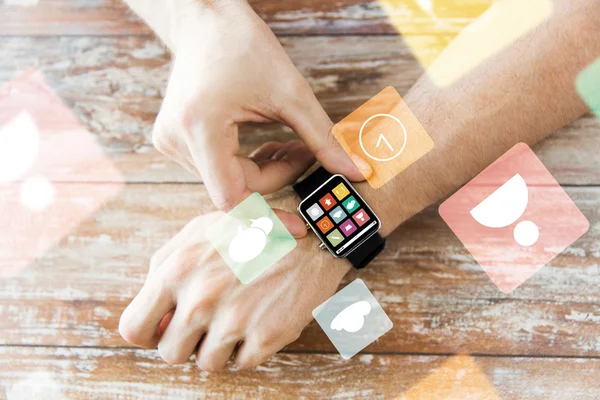 Close up of hands setting smart watch with icons — Stock Photo, Image