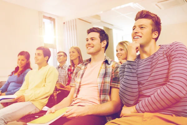 Group of smiling students in lecture hall — Stock Photo, Image