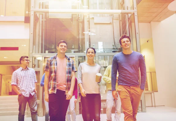 Group of smiling students with paper coffee cups — Stock Photo, Image