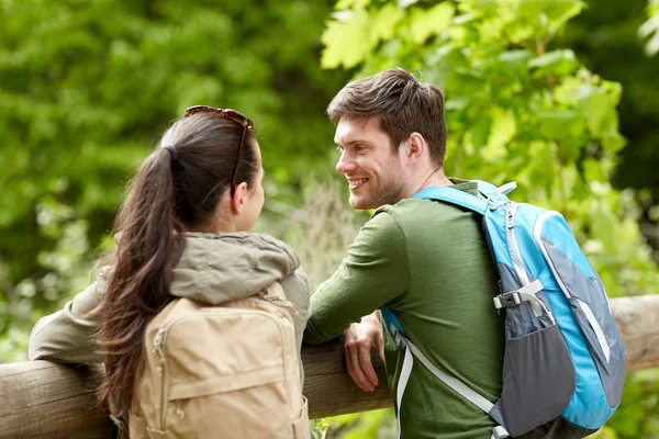 Sorrindo casal com mochilas na natureza — Fotografia de Stock