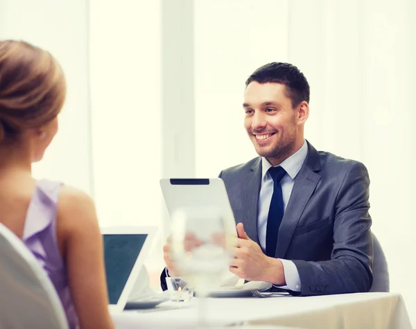 Man with tablet pc looking at wife or girlfriend — Stock Photo, Image