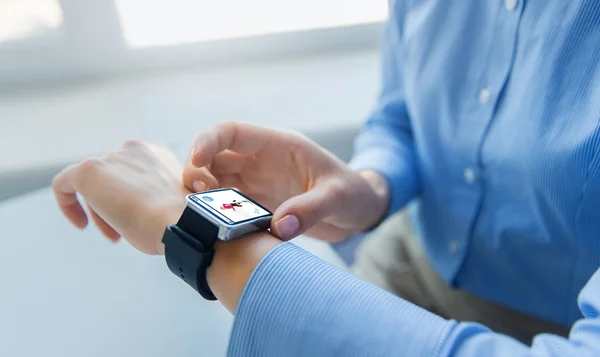 Close up of hands with fitness app on smart watch — Stock Photo, Image