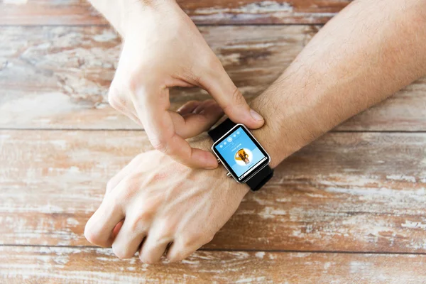 Close up of hands with music player on smart watch — Stock Photo, Image