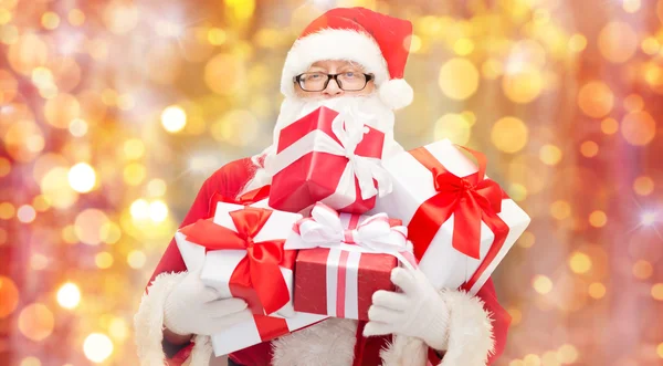 Man in costume of santa claus with gift boxes — Stock Photo, Image